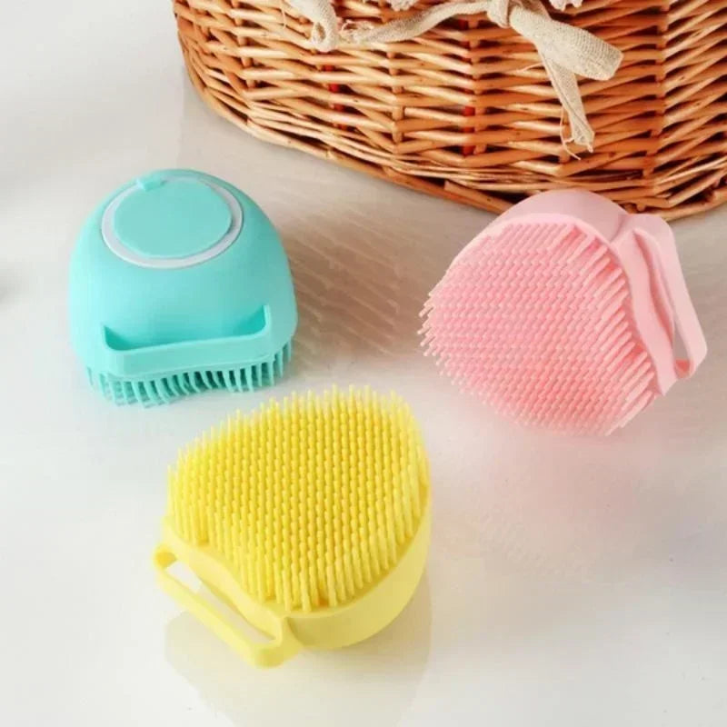 Three colorful scrubbing brushes on a light surface with a woven basket in the background.