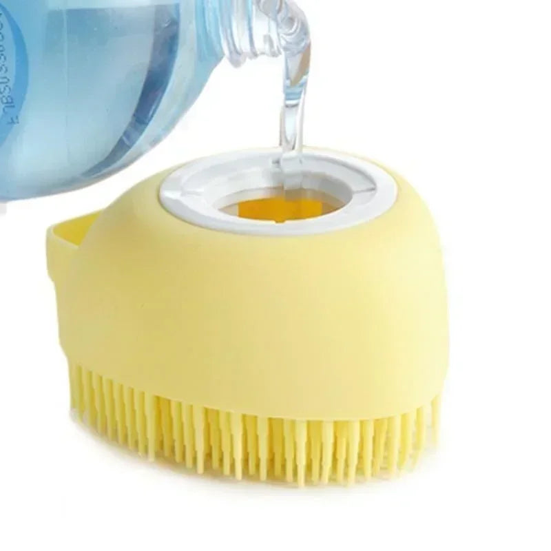 Yellow scrubber brush for pets with a white centre being filled with water from a blue bottle on a white background